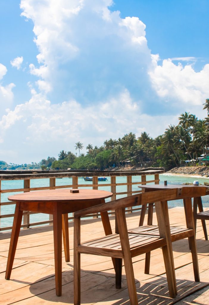 Tables and chairs await at a beautiful seaside spot.